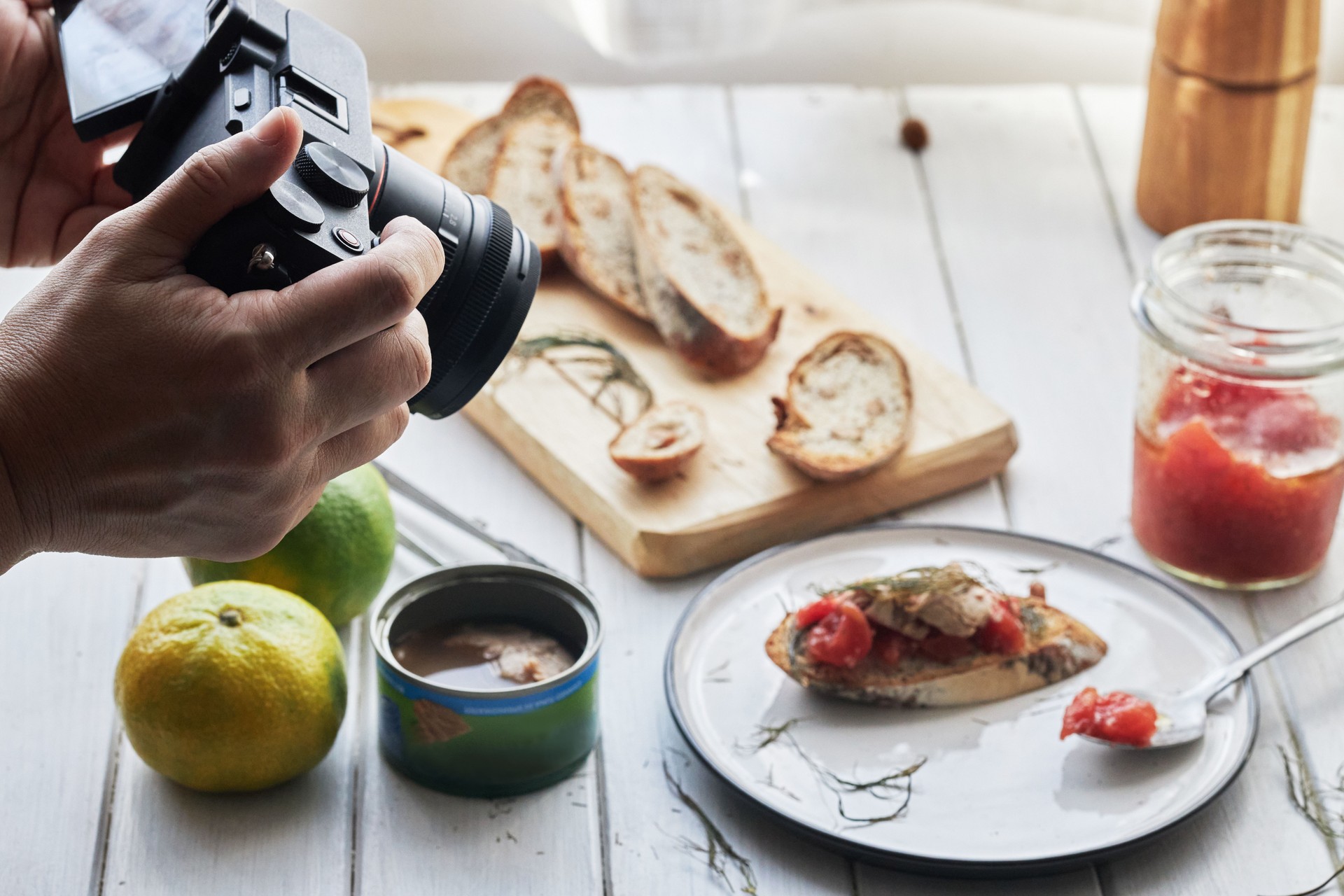 person taking pictures of food on dining table person taking pictures of food on dining table